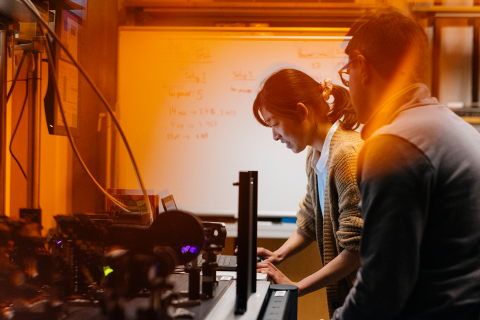 Grad student in lab looking at instruments